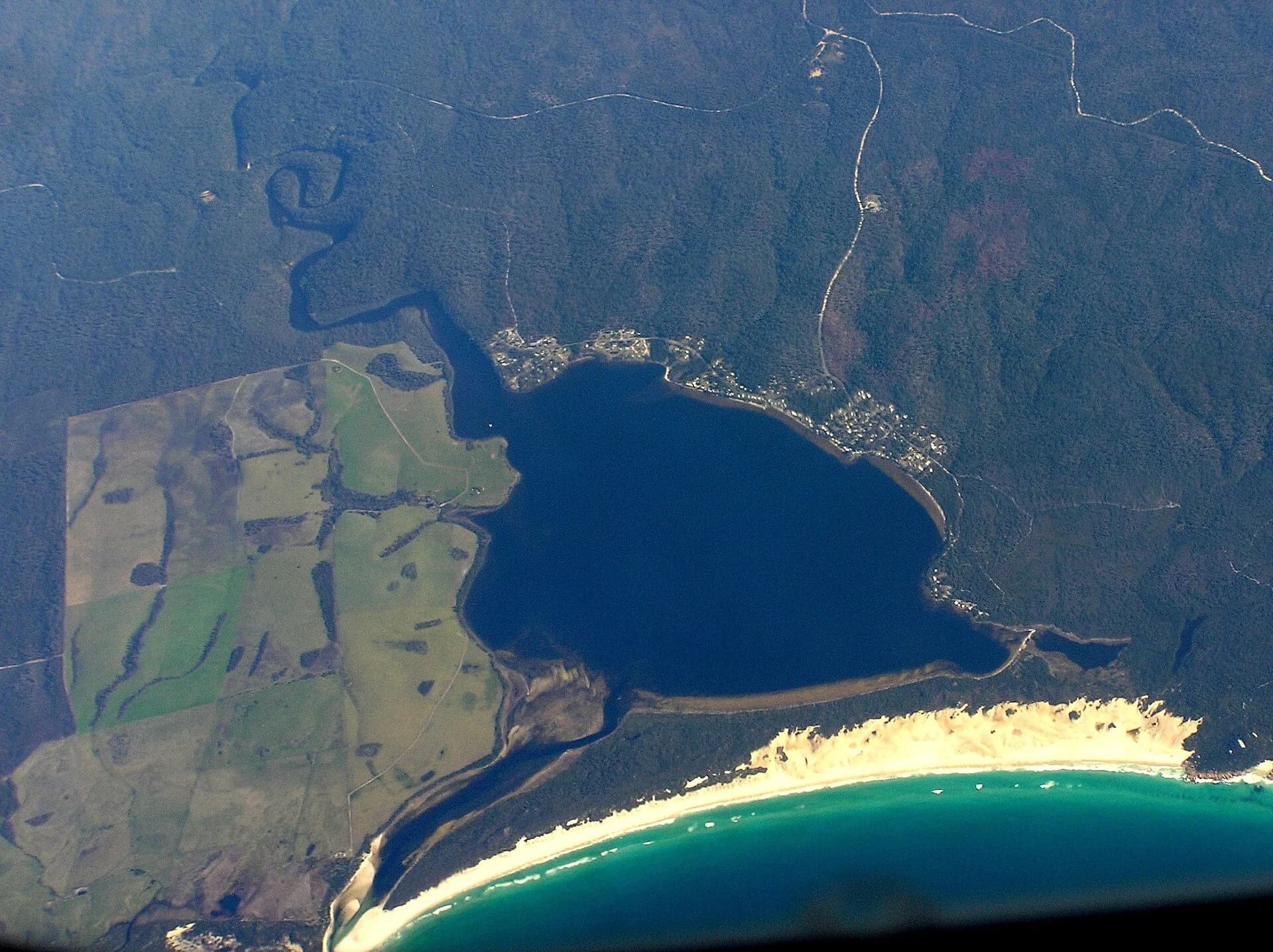 Aerial view across Ansons Bay and its forested shoreline