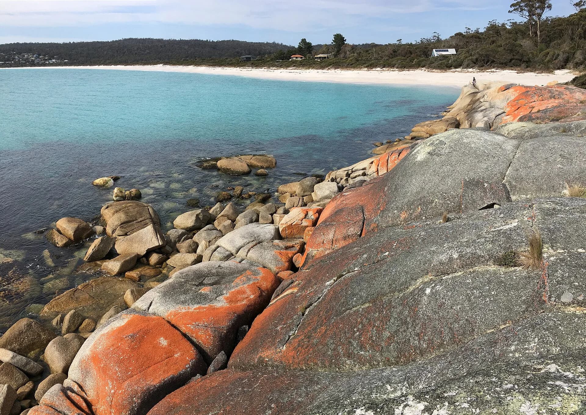 Granite shoreline and clear water at Binalong Bay