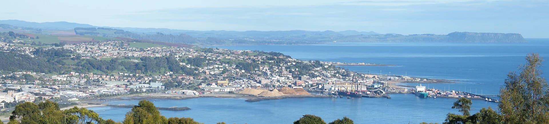 Wide view over Burnie, its port and surrounding hills