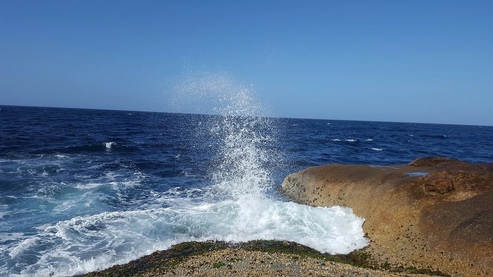 Sea spray at Okines Beach