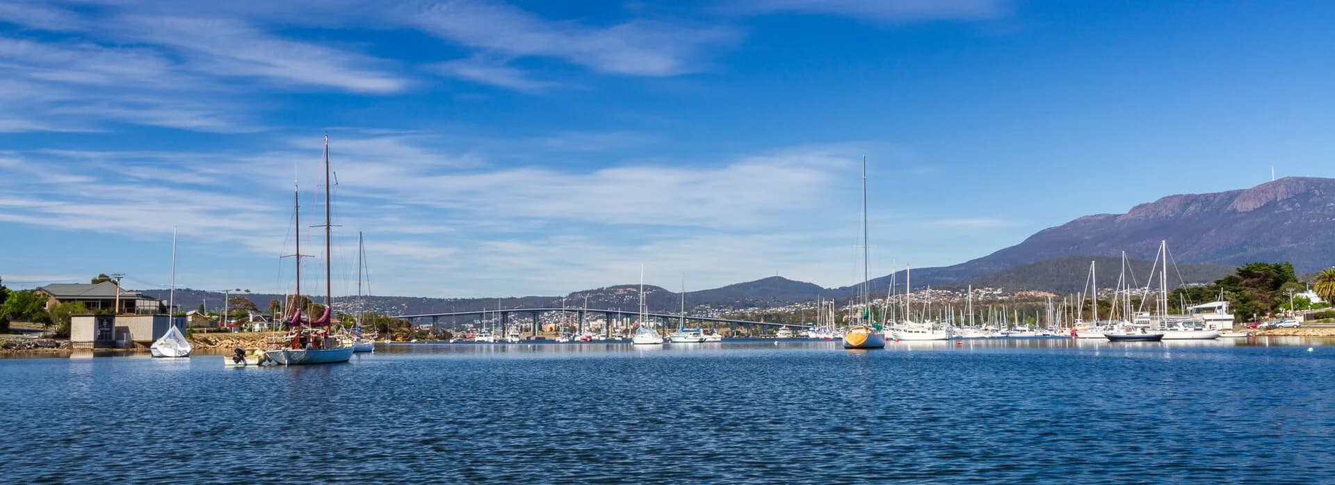 Eastern-shore bays and settled slopes beside the Derwent