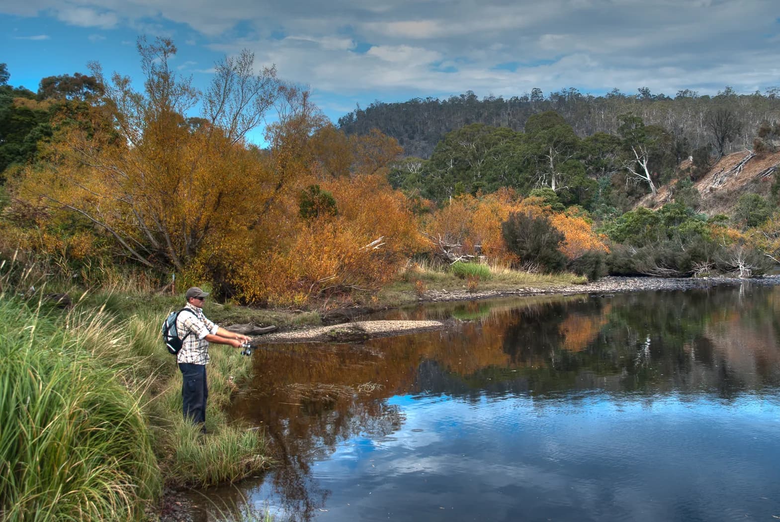 Angler fishing for trout in a Tasmanian inland water