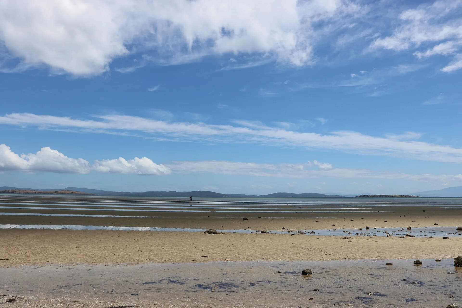 Low sandy beach and calm water at Dunalley
