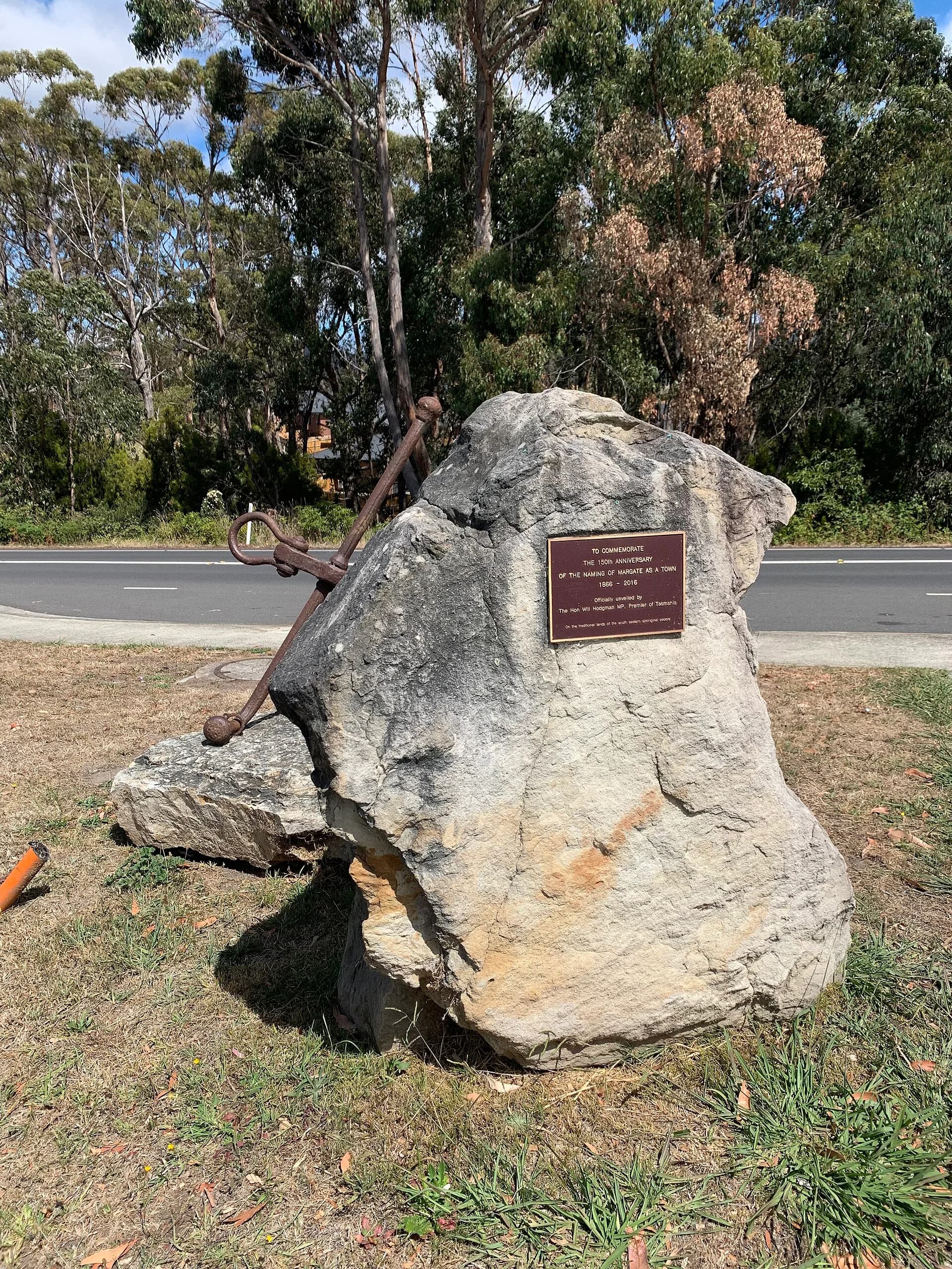 Commemorative stone in Margate beside a planted public space