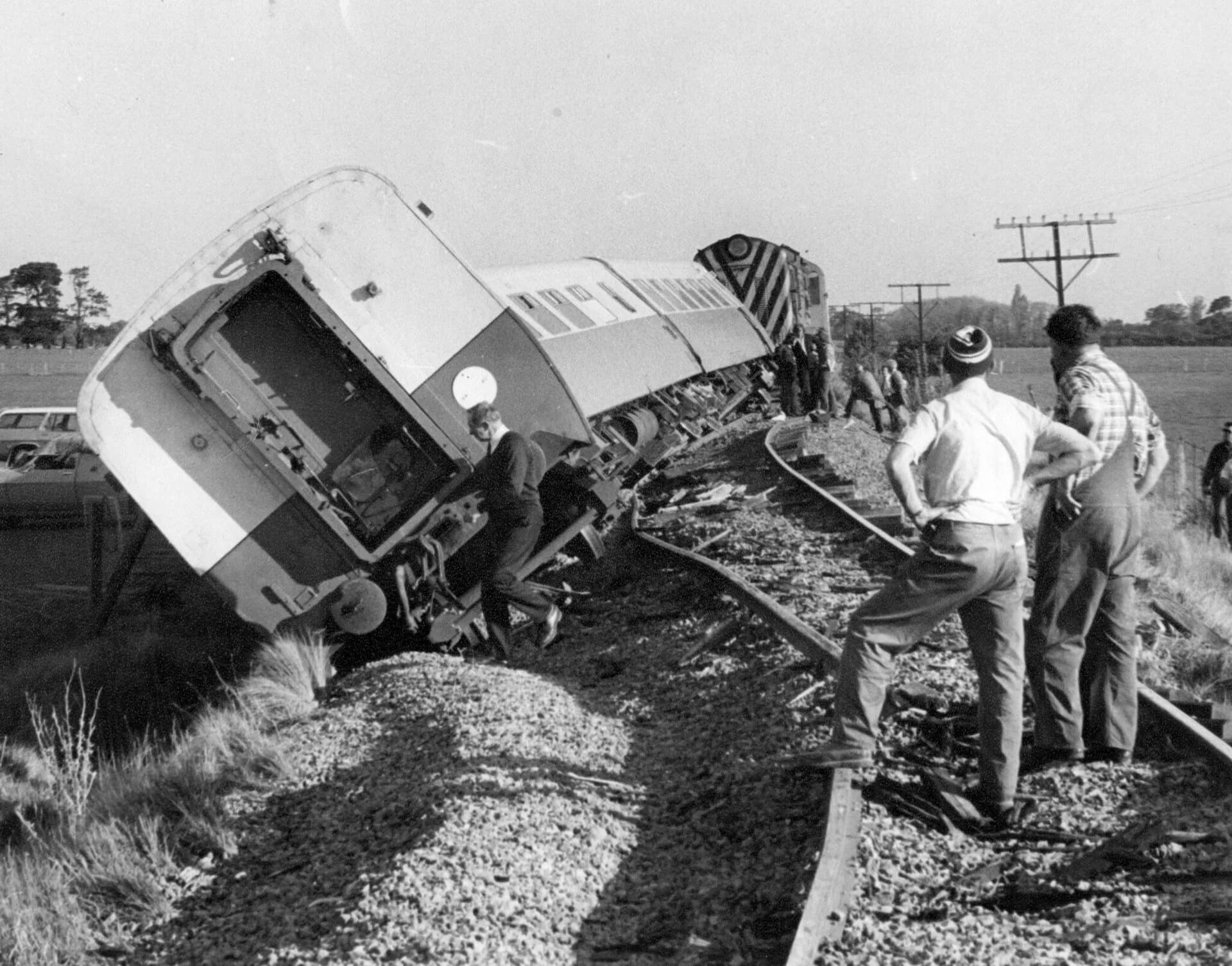 Railway workers beside derailed Tasman Limited carriages