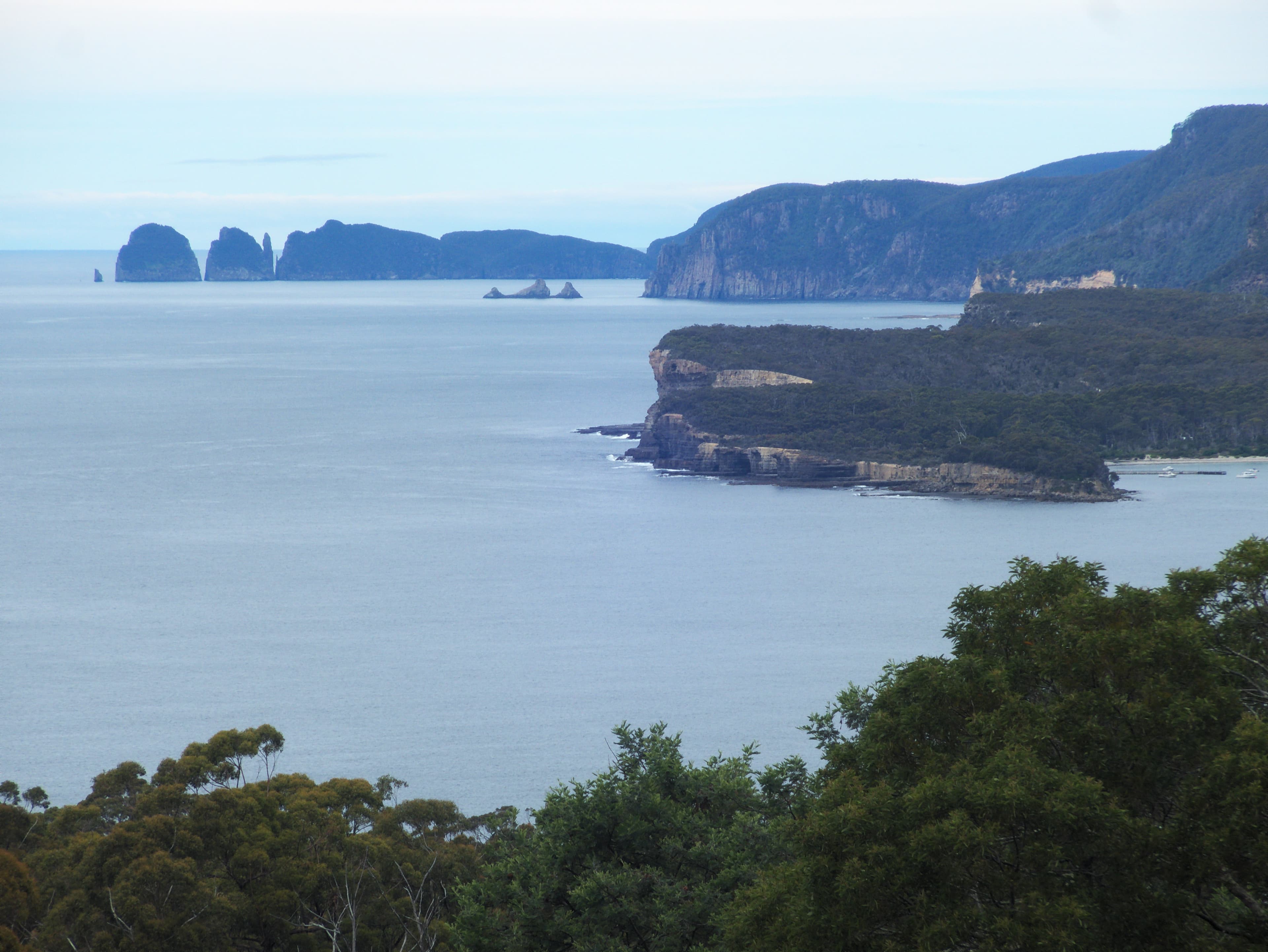 View from the Tasman Bay National Park Lookout on Pirates Bay Drive, Tasmania, with Cape Hauy and The Lanterns in the distance on the left, and Fossil Island in the centre to the right.