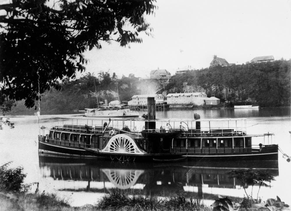 Natone (ship). Paddle steamer Natone on the Brisbane River, opposite Kangaroo Point in 1894. The Naval Stores can be seen in the background, also St. Mary's Church on top of the Kangaroo Point cliffs.